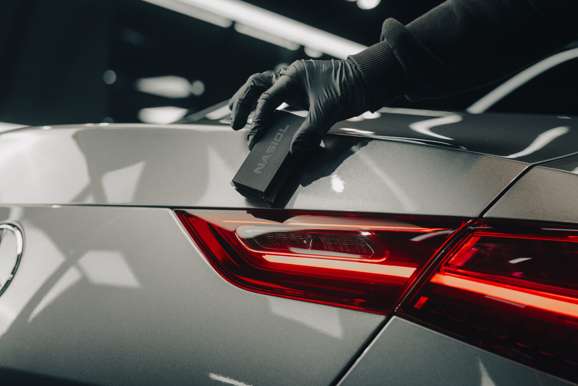 Ceramic coating applicator being used on a silver vehicle by Glasshouse Automotive